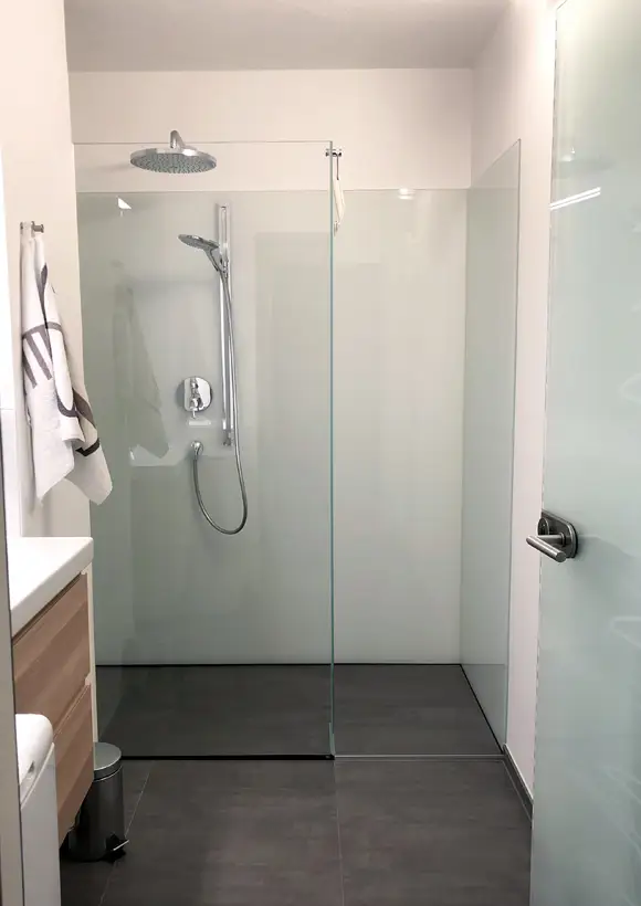 In weiß lackierte Glasrückwand mit Fixverglasung und Stabilisationsstange